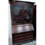 A 1930s oak bureau bookcase