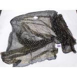 A black and gold assuit shawl. Damage and repairs