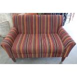 A small John Lewis sofa upholstered in brightly coloured striped fabric. 50' wide