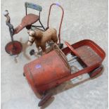 A vintage pedal car, a Tri-Ang tricycle and a push-along horse