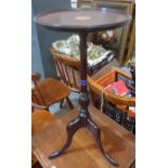 A mahogany and inlaid wine table on tripod support