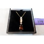 An 18ct topaz and diamond pendant on 9ct chain. 7.1g gross