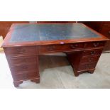 A yew veneered pedestal desk with leather inlet top. 60' wide. Of recent manufacture