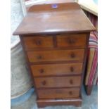 A small Victorian walnut chest of two short over four long drawers on bracket feet. 16' wide