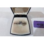A white stone solitaire ring. In gold marked 9ct. Size R
