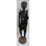An African carved wood male figure. 29' high