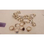 Six gemset rings, one marked 9ct, together with a bead necklace