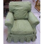 A 1920s upholstered armchair in the style of Howard & Co