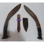 Two kukri knives (no scabbards) and a small sheathed knife