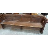 An oak and elm church pew. 86' long