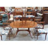 A Regency style yew veneered twin pedestal dining table and set of six sabre leg chairs