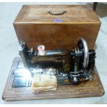 A Faudels sewing machine in inlaid case