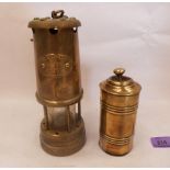 A miner's brass lamp and brass tobacco tin
