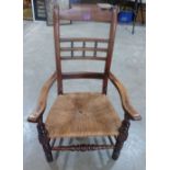 A 19th century elbow chair with rush seat