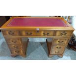 A yew veneered pedestal desk with leather inlet top. 48' wide