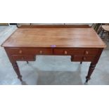 A Victorian mahogany writing table on turned legs. 47' wide