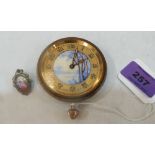 A 1920s Swiss travelling clock with painted dial, movement runs, together with a base metal and