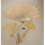 A down feather fan, brise fan and one other