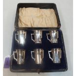 A George V cased set of six silver shot tyg cups. Chester 1910. 4ozs 17dwts