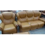 A tan leather three seater sofa and armchair