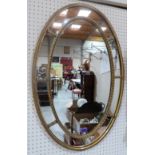 An Edwardian gilt framed oval wall mirror. 30' high x 19½' wide