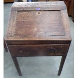 A George III oak bureau, the sloping fall over a frieze drawer, raised on square legs. 24' wide