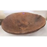 A rustic dugout treen bowl with iron applied rim. 25' diam. Old repairs