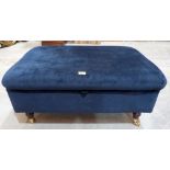 A blue upholstered ottoman. 37' wide