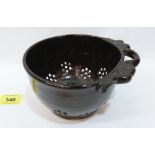 A treacle glazed pottery strainer by the Irish potter Christopher Patton. Impressed mark. 6½'