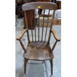 A 19th century strut back elbow chair with elm seat