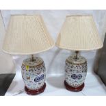 A pair of Chinese famille-rose decorated table lamps in the form of garden seats, with pleated