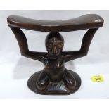 An African tribal carved figural headrest. 8' high