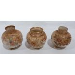 A Trio of Doulton Burslem jars, painted with flowers on a blush ivory ground and enriched with