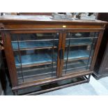 An oak glazed bookcase. 57' wide