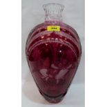 A ruby overlaid glass inverted baluster vase, cut with pine trees and flowers; acid etched and