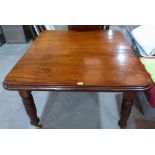 A Victorian mahogany dining table on turned legs, extending to 66' long with one extra leaf.