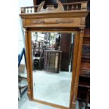 A Victorian oak looking glass with bevelled plate. 62' x 36'