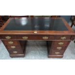 A Victorian walnut pedestal desk with inlet top