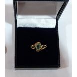 A green tourmaline solitaire ring. In gold marked 750. 3g gross . Size N
