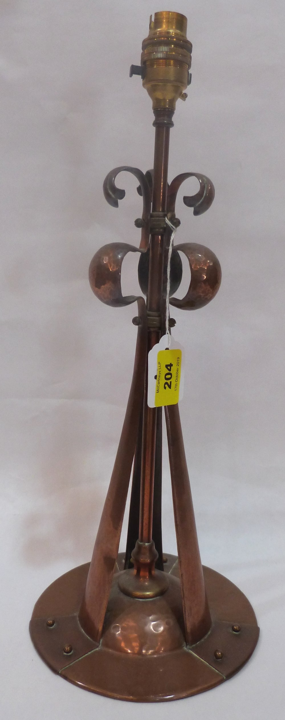 An Arts and Crafts planished and wrought copper lamp base in the manner of Liberty & Co 14½' high