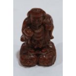 An oriental carved boxwood figure of a man carrying a sack and a mallet. 2¼' high