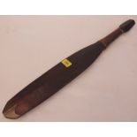 An ethnic hardwood paddle with leather bound handle and brass mounted tip. 23½' long