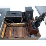 A box of Victorian camera plates, two leather cases and an early projector