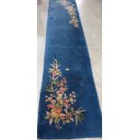 A Chinese blue ground carpet runner. 140' x 31'