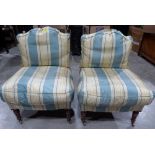 A pair of Victorian Howard style upholstered chairs on turned legs