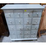 A painted chest with an arrangement of twenty drawers, raised on bracket feet. 34' wide