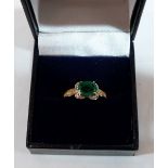 An emerald and diamond ring. In gold marked 375. 2.5g gross. Size N