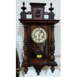 A Vienna style walnut wall clock with two train movement. 27' high