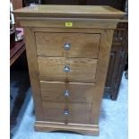 A light oak chest of four drawers on bracket support. 24' wide