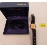 A 9ct Tissot Stylist gentleman's wristwatch. Engraved back, the champagne dial with baton numerals .